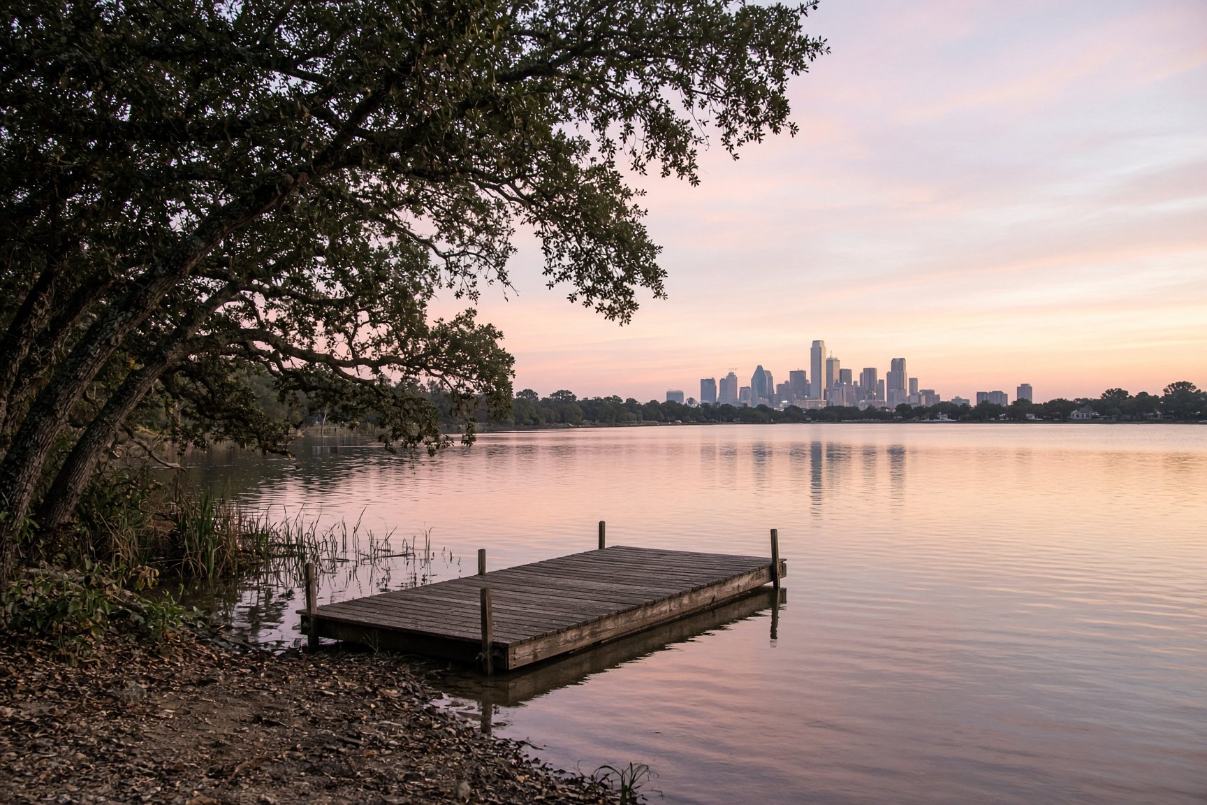 A quiet dock at dawn on still water, with trees along the shore.